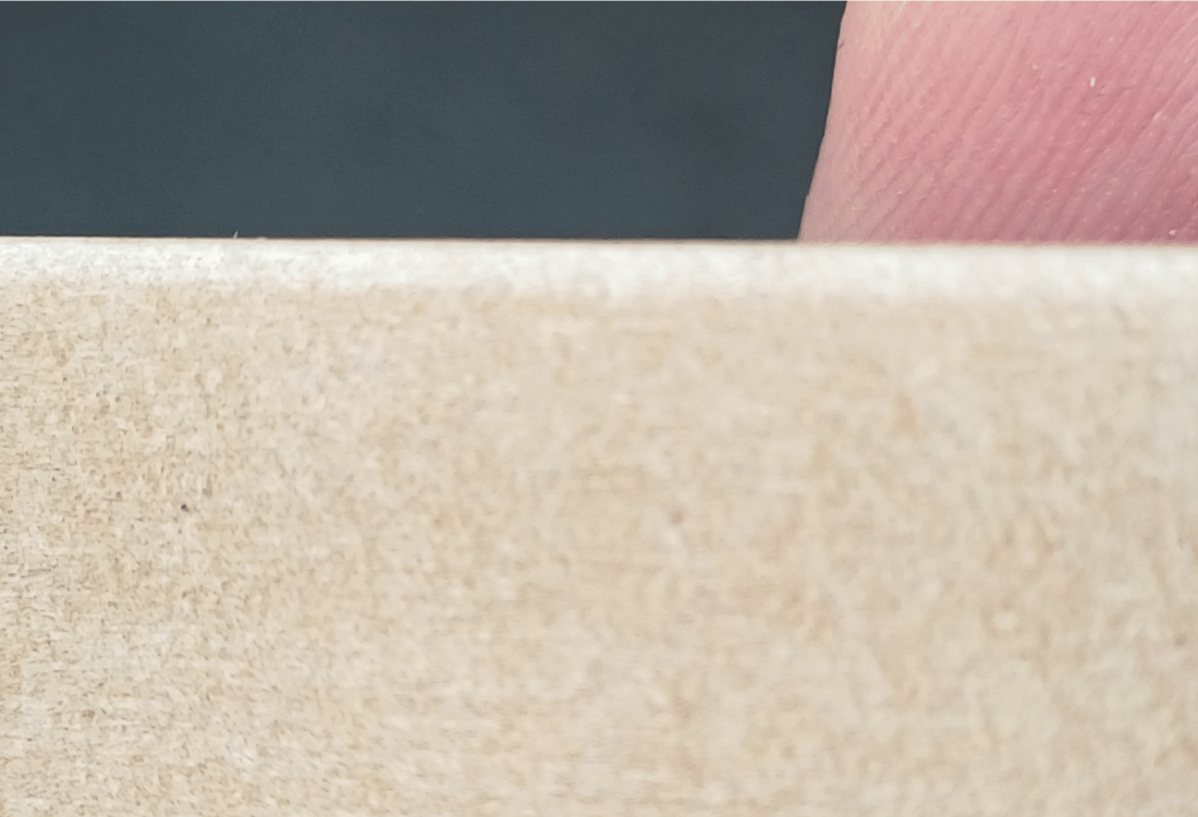 A Blue60 Timberex Wedge being hold by a person who is going to use to ensure a door remains compliant. 